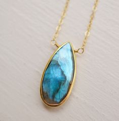 Labradorite encapsulates grace, mystery, and the timeless allure of natural beauty... Handcrafted with exquisite attention to detail, this Labradorite pendant showcases the gem's iridescent blues, greens, and grays, which flicker and change with the light. Labradorite, a feldspar originally found in Labrador Island, Canada, was believed to be fallen fire from the Aurora Borealis by the Inuit people. It is a protective gemstone, said to help support us through transformation and everyday life cha Labradorite Teardrop Beads For Jewelry Making, Labradorite Teardrop For Jewelry Making, Teardrop Labradorite For Jewelry Making, Labradorite Gemstone Teardrop Pendant Jewelry, Teardrop Labradorite Jewelry Gift, Labradorite Drop Jewelry For Gift, Labradorite Teardrop Pendant Jewelry Gift, Mystical Teardrop Gemstone Jewelry, Handmade Labradorite Drop Jewelry