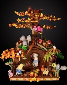 an elaborately designed tree house with lots of figurines on it's base