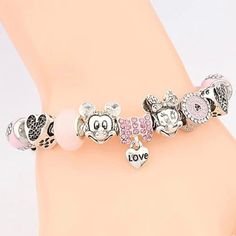 You can’t say you love Minnie Mouse if you don’t have one of these cute pink charm bracelets on your arm or in your jewelry box. These quality charms catch the light and steal the show in any room you enter. They are also removable which means that you can put them on another bracelet or jewelry piece and continue your slay. DIY your charm bracelet or mix and match, whatever the case create your very own unique style. Buy this bracelet to invest in your Disneyland drip or gift this luxury charm Pink Heart Charms For Mother's Day, Pink Metal Novelty Jewelry, Novelty Pink Metal Jewelry, Pink Themed Birthday Bracelets, Themed Pink Bracelets For Birthday, Cute Metal Charm Bracelet, Pink Metal Bracelets For Gifts, Personalized Pink Novelty Bracelets, Trendy Silver Friendship Charms