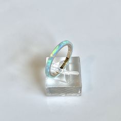 **Current processing time has been reduced to 6-8 weeks. Each ring is made to order in the order received. Thank you so much for your support and patience! 🎁 FREE Wood Ring Box with every ring purchase! 2mm wide Kyocera Solid Opal Ring shimmering with Blue and Turquoise hues. The opal is translucent and when the light hits it, the gold ring comes through in hints of pink. Wrapped around a 14K Gold filled band. Perfect for stacking with a wedding ring or stand alone for a minimalist look. Great Unique Blue Opal Ring, Blue Opal Gemstone Ring As Gift, Blue Opal Ring Gift, Handmade Blue Opal Rings, Opal Ring, Opal Wedding Ring, Handmade Iridescent Opal Ring, Opal Birthstone Ring, Solid Opal Ring