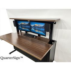 the computer desk has two monitors on it