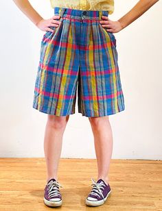 This is a fabulous pair of 80s vintage "Giorgio Sant'Angelo" rainbow plaid shorts! They are a linen cotton blend, woven with a lovely palette in shades of yellow, blue, red and purple. The high waist has four wide belt loops. There are two vertical welted front pockets and one inset back pocket on the right which buttons closed. They're unlined and have a 1" hem allowance. These cute shorts have a pleated front, a Bermuda shape, and close with two small front buttons and a gray "RJ" brand nylon Retro Short Bottoms With Elastic Waistband, Casual Multicolor Short Pants, Retro Cotton Bottoms With Short Length, Retro Plaid Bottoms For Spring, Multicolor Bermuda Bottoms For Spring, Retro Bermuda Shorts For Summer, Casual Multicolor Bermuda Bottoms, Multicolor Casual Shorts, Casual Multicolor Short Leg Bottoms