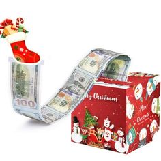 a red box with money in it sitting next to a christmas stocking