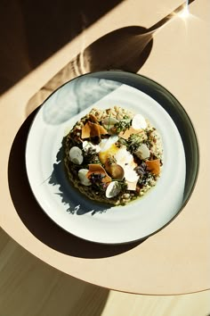 a white plate topped with food on top of a wooden table