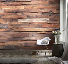 a white chair sitting in front of a wooden wall