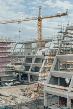 the building is under construction with cranes on top