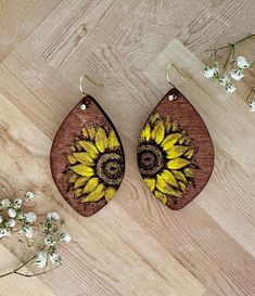 Elevate your accessory game with these stunning hand-painted floral earrings!  Designs are meant to stand out and showcase the intricate floral motifs that celebrate the beauty of the outdoors.  Each pair is meticulously crafted by me, ensuring that no two pairs are exactly alike making them perfect for everyday wear without compromising on style making them great for everyday wear or special occasions.   Crafted from high-quality wood, these earrings are lightweight and comfortable. **VARIOUS STYLES** When ordering please ensure you've selected the correct one.   Materials: wood, genuine leather, paint, and high-quality beads.  Care Instructions: To maintain the beauty of your earrings, avoid exposure to water and store them in a dry place. Gently wipe with a soft cloth to clean.  Shippin Bohemian Sunflower Design Flower Earrings As Gift, Artistic Flower-shaped Jewelry For Crafting, Bohemian Sunflower Earrings For Gift, Bohemian Sunflower Earrings As Gift, Bohemian Sunflower Design Earrings For Gift, Artistic Flower-shaped Earrings With Ear Wire, Hand Painted Yellow Earrings For Summer, Bohemian Flower Earrings As Gift, Adjustable Flower-shaped Nature-inspired Earrings