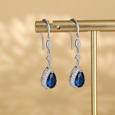 Polished metal and sparkling stones come together to create this unique jewelry, giving it a sophisticated and sparkling look. Made from sterling silver, these earrings make a stunning fashion accessory.Carat Weight: 2.77 ctStone Size: 6*9 mmStone Type: Jeulia® StoneNumber of Stones: 2 Stone Shape: PearStone Color: Sapphire BlueCarat Weight: 0.552 ctStone Size: 1.2,1,0.8 mmStone Type: Jeulia® StoneNumber of Stones: 56 Stone Shape: RoundStone Color: Diamond WhiteWeight: 2.95 gWidth: 8.8 mmHeight: Teardrop Gemstone Jewelry For Evening, Sterling Silver Fine Jewelry Crystal Earrings For Party, Elegant Sterling Silver Diamond Earrings For Anniversary, Silver Fine Jewelry Earrings, Elegant Sterling Silver Crystal Earrings, Sterling Silver Dangle Crystal Earrings For Evening, Silver Earrings Fine Jewelry, Fine Jewelry Crystal Earrings For Anniversary, Elegant Pear-shaped Earrings For Evening