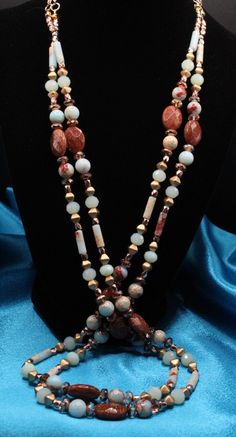 The necklace has lots of personality and charisma with the beautiful blues, greens, rust and sand colors of the 'Aqua Terra' Jasper and 'Sky Blue' Jasper which matches perfectly with the faceted 'Gold Stone' oval stone beads.  I also added 'pink and copper' 2-tone Czech glass rondels; and the Czech 'gold coated' glass bicone beads; and matching rose gold accents.  I then completed the ensemble with rose gold chain and lobster clasp.   This necklace combination would complete any fall outfit with Glass Rondels, Snakeskin Jasper, Brown Jasper, Blue Jasper, Stone Necklace Set, Beaded Jewelry Necklaces, Aqua Terra, Bracelet Craft Diy, Rose Gold Accents