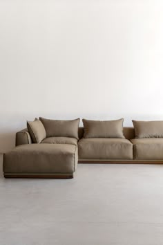 a large sectional couch sitting on top of a white floor