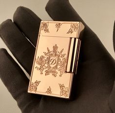 a gold lighter sitting on top of a black glove