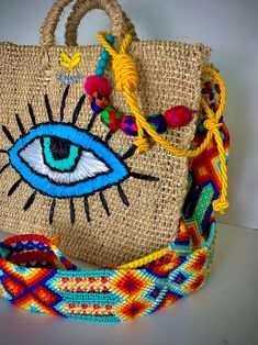 a woven bag with an eye on it