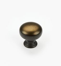 an antique brass knob on a white background