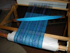 a weaving machine with blue yarn on it