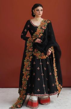 Pakistani Black Dress In Pishwas Style For Wedding Unstitched Embroidered Chinon Gown, Embroidered Dola Silk Wedding Gown, Semi-stitched Gown With Dupatta For Traditional Ceremonies, Traditional Dola Silk Dresses For Wedding, Black Sharara With Floral Embroidery For Reception, Chinon Dresses With Intricate Embroidery For Traditional Ceremonies, Embroidered Dola Silk Wedding Dress, Elegant Raw Silk Gown For Traditional Ceremonies, Bollywood Style Chinon Dress For Traditional Ceremonies