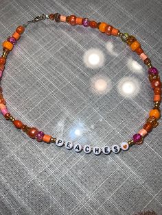 beaded necklace inspired by justin bieber's song 'Peaches' each necklace will be slightly different, no two necklaces will be exactly the same but color & word will be the same 100% hand made!  can pick different lengths for necklace would be perfect accessorie to wear for his new tour!  made as they are ordered, please keep in mind length of time when ordering if you are ordering to wear to a certain show these necklaces are made to order, meaning i don't have a certain quantity, they will be m Justin Bieber Bracelet, Trendy Customizable Adjustable Necklace, Trendy Adjustable Customizable Necklaces, Trendy Adjustable Customizable Necklace, Trendy Adjustable Beaded Necklace, Adjustable Orange Beaded Necklace With Letter Beads, Trendy Adjustable Orange Beaded Necklace, Trendy Adjustable Orange Beaded Necklaces, Trendy Orange Jewelry With Letter Beads