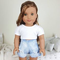 a doll is standing on a bed with her hands in her pockets and looking at the camera