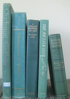 a stack of books sitting on top of a wooden table