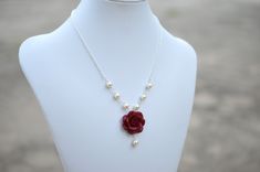 "Featuring 25mm Hand Sculpted Deep Red (Garnet) Rose and pearls Centered Necklace. Matching Red Rose Earrings: https://www.etsy.com/listing/165095225/red-rose-and-pearls-earrings-dangle-rose?ref=shop_home_active Note : Drop a note if you prefer Fired red rose or Succulent Rose, otherwise will be shipped as Garnet Red Rose. Material and size : Rose Clay Flower is approximately 25-26mm across. 6-8mm Ivory /cream/Off-white glass pearls. White pearls available. Swarovski available with additional co Red Rose Jewelry, Red Rose Earrings, Red Flower Necklace, Necklace Matching, Garnet Red, Clay Flower, Sugar Land, Rose Necklace, Necklace Red