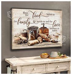 a painting on the wall above a table with bread and coffee items in front of it