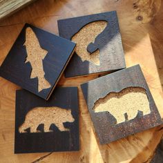 four pieces of wood with cut out animals on them