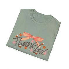 This girly coquette Thanksgiving Fall T-Shirt exudes a warm and festive vibe, perfect for celebrating the autumn season. It is relevant to those who enjoy expressing their love for fall holidays and festivities. Product features - Made from 100% ring-spun cotton for a lightweight and comfortable feel - Classic fit with crew neckline for versatile styling - Ethically grown and harvested US cotton for sustainability - Features ribbed knit collar and shoulder tape for durability - Perfect for printing with specially spun fibers for smooth fabric Care instructions - Do not dryclean - Machine wash: warm (max 40C or 105F) - Do not bleach - Tumble dry: low heat - Iron, steam or dry: low heat Holiday Letter Print T-shirt For Fall, Cute Winter Tops As Gift, Holiday Crew Neck Tops For Fall, Cute Winter Tops As A Gift, Cute Long Sleeve T-shirt As Gift, Green Tops For Fall Holiday, Cotton T-shirt For Fall Holiday, Casual Fall Holiday T-shirt, Casual T-shirt For Fall Holiday