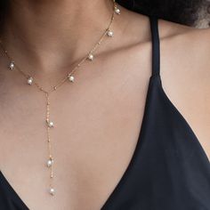 add a subtle touch to your look with our Sun Is Shining Lariat Necklace. expertly crafted for a soft and elegant look, this necklace is the perfect accessory when you want to make a delicate statement. 18k gold pvd over 316L stainless steel 4mm glass pearls water & tarnish resistant 15.5" long + 2" extender 3.5" long drop Gold-plated Lariat Necklace With Delicate Chain, Elegant Gold-plated Lariat Necklace, Gold-tone Gold Plated Lariat Necklace, Gold Tarnish-resistant Lariat Necklace, Elegant Adjustable Gold-tone Lariat Necklace, Lariat Necklace, 18k Gold, Gold