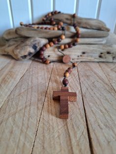 Wooden rosaries , Exquisite Handcrafted Wooden Rosary , Handmade Natural Wood  Beads Rosary , Rosary Necklace , Spiritual Gift  Prayer Beads This exquisite rosary is meticulously crafted from various natural woods, featuring a beautifully hand-carved wooden cross and 8mm wooden beads, all made by hand. The total length of the rosary is approximately 47 cm (18.5 inches). Each bead and the cross are carefully handcrafted, ensuring that every piece is unique. Perfect for personal devotion or as a m Spiritual Rosary With Large Beads, Adjustable Crucifix Rosary, Brown Lariat Beaded Necklace Gift, Brown Lariat Beaded Necklace For Gift, Adjustable Bohemian Cross Beaded Necklaces, Meditation Rosary With Wooden Beads And Cross Shape, Hand-strung Lariat Beads For Gift, Hand-strung Lariat Beads As A Gift, Handmade Cross Jewelry For Meditation