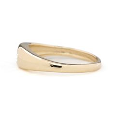 a yellow gold wedding ring with white diamonds on the sides and a thin band in the middle