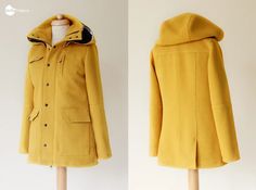 the coat is yellow and has a black hood