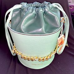 Anna Paola Two-Tone Italian Leather Green Bucket Bag Cinch Bag Gold Chain Nwt Style: Morena Outer Is Light Sage Green, Inner Leather Liner Deeper Succulent Green. Gold Chain Details. Detachable Hand Strap And Shoulder Strap Included. Dust Bag Included. Drawstring With Gold Tips. 10" (W) X 8" (H) X 6" (D) Gorgeous Pebble Leather On Outside And Supple Smooth Leather On Inside. Black Satin Lining. Bucket Shoulder Bag With Chain Strap, Chain Strap Bucket Shoulder Bag, Chic Chain Bucket Bag, Elegant Chain Bucket Bag, Trendy Bucket Bag With Gold-tone Hardware, Trendy Bucket Bag With Chain Strap For Travel, Travel Bucket Bag With Chain Strap, Chic Pouch Bucket Bag With Chain Strap, Chic Bucket Bag With Chain Strap