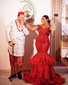 a man and woman dressed in traditional mexican garb