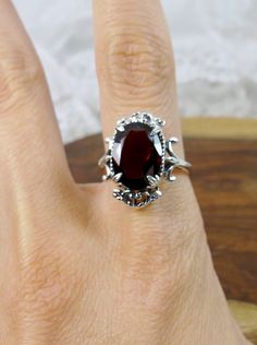 "Natural Garnet Gemstone Ring Vampire Design#84 MADE TO ORDER Inspired by Gothic & Renaissance era jewelry, I now offer this lovely Antique styles ring in sterling silver. This gorgeous ring is set with a VS to VVS genuine natural merlot-red garnet gemstone. The oval faceted cut 6.5ct to 7ct ct oval gem is 14mm (9/16th of an inch) Long by 10mm Wide (3/8th\"). The ring sits 7mm off the finger. The inside of the band is marked 925 for sterling. Notice the intricate leaf design of the filigree Formal Garnet Rings With Accent Stones, Formal Garnet Rings With Gemstone Accents, Heirloom Ruby Ring With Gemstone Accents For Formal Occasions, Red Oval Cabochon Ring For Formal Occasions, Classic Rings With Oval Cabochon Gemstone Accents, Classic Oval Gemstones For Wedding, Victorian Oval Ruby Ring For Formal Occasions, Victorian Oval Rings For Formal Occasions, Classic Oval Red Birthstone Ring