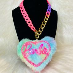 Keeping Barbie Close To Your Heart Has Never Been Easier Because Now We Bring You This Beautiful Handmade Barbie Necklace. It Features A Gorgeous Pink Barbie Doll Logo In Acrylic Surrounded By Multi Colored Fur In The Shape Of A Heart With A Multicolor Chain. This Necklace Is Definitely A Eye Catcher And Plays Well With Multiple Outfits. Trendy Personalized Pink Necklace, Cute Pink Jewelry With Chain, Cute Pink Jewelry With Chain Detail, Pink Barbie Doll, Barbie Necklace, Barbie Jewelry, Baby Alive Doll Clothes, Fandom Jewelry, Irregular Choice Shoes