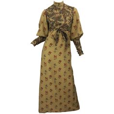 Beautiful 1970s Victorian inspired Autumnal lightweight wool challis long sleeve maxi dress ! Features warm tone of khaki, brown, red, burgundy, green and orange. Printed flowers and leaves throughout. High neck with bishop sleeves. Hidden zipper up the back with hook-and-eye closures. Buttons at each sleeve cuff. Tie belt at waist can be tied in the front or back. Fully lined. In great condition Approximately Size Medium Measurements: 34 inch bust 29 inch waist ( can be made smaller with attach Challis Dress, Silk Tank Dress, Long Halter Dress, 70s Maxi Dress, Fall Vintage, Seventies Fashion, Designer Evening Dresses, Warm Tone, Maxi Gown Dress