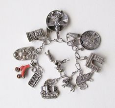 "A wonderful sterling silver bracelet with some stamped and some not stamped sterling silver and other metal charms. Big and small charms, chunky and changly! Bracelet is 6.5 inches long. Here are the charms: 1. Salzberg castle: stamped 800, .75 inches wide 2. Mexican trumpeter: no stamp, 1 inch tall (silver) 3. Ram: stamped Sterling, .50 inches 4. Deutschland : Stamped 800, 1 inch 5. Arc de triomphe: no stamp, .75 inches wide.25 inches wide (silver) 6. 1969 First Lunar LandingApollo 11: stamped Antique Nickel-free Collectible Charms, Unique Metal Charm Bracelet Collectible, Unique Nickel-free Silver Charm Bracelet, Unique Metal Charm Bracelet, Unique Silver Nickel-free Charm Bracelet, Silver Symbolic Jewelry Souvenir, Unique Silver Jewelry With Vintage Charm, Spiritual Silver Jewelry Souvenir, Spiritual Silver Jewelry With Dangling Charms