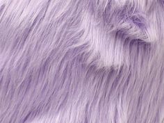 closeup of purple furry material with white fur on the top and bottom half of it