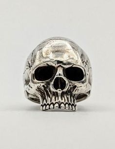 a silver skull ring with black eyes