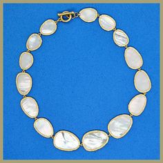 An iconic design, beautiful and timeless. Graduated, irregularly shaped petals of mother-of-pearl, each surrounded by a brushed golden edge. The natural mother-of-pearl nacre has a lustrous sheen that contains a rainbow of colors, changing with the light. Lightweight and delicate, and perfectly proportioned. Toggle clasp for easy on/off. 16" long, with petals that range from 3/4" to 1.25" in length. Imported for the Leila Jewels Glam Collection Elegant Shell-shaped Pearl Drop Necklace, Elegant Jewelry With Oyster Bracelet, Elegant Gold Shell Necklace With Pearl Drop, Formal Necklace With High Luster Mother Of Pearl, Mother Of Pearl Shell Necklace For Wedding, Elegant Gold Shell-shaped Pearl Necklace, Elegant Shell Necklace With Pearl Pendant, Elegant Gold Shell Pearl Necklace, Elegant Mother Of Pearl Shell Necklace Gift