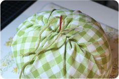 a green and white checkered pillow sitting on top of a table