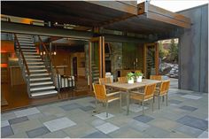 a table and chairs on a patio with stairs