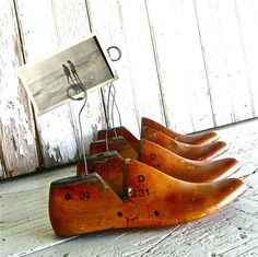 four wooden shoes are sitting on the floor next to a sign with an image hanging from it