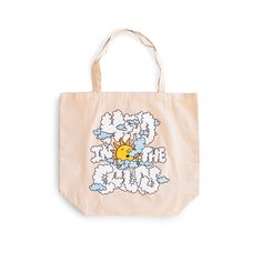 front view image of tote bag from Bather that reads head in the clouds in bubbled text with a drawing of a sun in the middle Casual Cotton Canvas Bag For Weekend, Large Capacity Cotton Tote Beach Bag, White Canvas Weekend Bag, White Cotton Canvas Bag For Weekend, Large Capacity Natural Cotton Beach Bag, Cotton Beach Bags For Daily Use, Travel Cotton Tote Beach Bag, Weekend Cotton Rectangular Bag, Beige Cotton Beach Bag For Travel