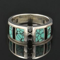 "Spiderweb turquoise ring with black onyx and black diamond accents designed by Mark Hileman. This woman's handmade band features 3 channel set round black diamonds flanked by alternating black onyx and spiderweb turquoise inlay. The 3 black diamonds weigh a total of .18 carats. The ring is 8.5mm wide at the widest point and will be made to order in your size in 3 to 6 weeks. This band is available in other color combinations and in 14k gold or stainless steel for an additional charge. It is han Black Round Cut Jewelry With Accent Stones, Luxury Jewelry With Multi-stone Round Shape, Luxury Multi-stone Round Jewelry, Fine Onyx Jewelry For Anniversary, Fine Jewelry With Inlay For Anniversary, Black Inlay Jewelry As A Gift, Modern Jewelry With Accent Stones For Anniversary, Black Jewelry With Inlay For Gift, Luxury Inlay Rings For Anniversary