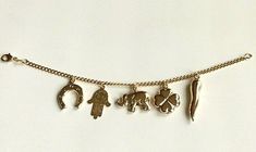 "18k gold filled charm (elephant,hamsa,clover,italian horn,horseshoe)bracelet for good luck and protection..7.5\" long . pulsera de buena suerte en18k gold filled. para proteccion y buena suerte.7.5\" largo." Gold Bohemian Charm Bracelet For Everyday, Bohemian Gold Charm Bracelet For Everyday, Gold Spiritual Charm Bracelet For Good Luck, Money Bracelet, Horseshoe Bracelet, Figaro Necklace, Italian Horn, Good Luck Bracelet, For Good Luck