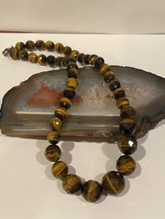 "This is a beautiful, vintage, genuine Tiger's Eye and sterling silver beaded necklace. The necklace measures about 18 inches. The round Tiger's Eye stones are vibrant and stunning. They measure 3/4\" in diameter for the largest one then tailor down to 5/8\", 1/2\" and 3/8\" in diameter. The necklace weighs a hefty 73.4 grams and is stamped 925. Perfect to wear on its own or add a large pendant. Very well-made and gorgeous! See picture for details. More gorgeous jewelry here, and some on BIG cle Vintage Faceted Beaded Necklaces, Vintage Faceted Beaded Necklaces For Gifts, Vintage Crystal Necklaces With Polished Beads As Gift, Vintage Crystal Necklaces With Polished Beads For Gift, Vintage Crystal Necklace With Polished Beads As Gift, Vintage Crystal Necklace With Polished Beads For Gift, Spiritual Faceted Beaded Necklaces, Vintage Round Gemstone Beads Jewelry, Spiritual Necklaces With Round Beads For Anniversary