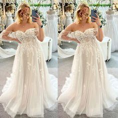 a woman taking a selfie while wearing a wedding dress in front of a mirror