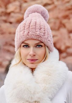 There are beanies, then there's the Blush Poppy Pom Beanie. Hand-knitted of faux fur yarn in a flattering, soft shade of Blush, the Poppy Pom has the perfect amount of body and stretch. Topped with a fun, whimsical 5" fur pom, the roomy 10"-high cap portion slips easily off and on, leaving hair uncrushed. Neutral and easy to style, the Poppy Pom dresses up and down. Make the Poppy Pom your signature accessory, knowing in this case, fabulous-ness is practical as well! The Poppy Pom Beanie is conveniently machine-wash. Create a gift set by adding the matching pull-through scarf (43109) and finger-less gloves (43100). Rest assured, all three pieces have the same convenient easy-care. Chic Beanie Hat For Winter, Chic Beanie For Winter, Winter Faux Fur Mink Hat, Fluffy Faux Fur Hat For Cold Weather, Chic Pink Winter Hat, Faux Fur Beanie For Fall, Faux Fur Beanie Hats For Fall, Fall Faux Fur Beanie Hat, Faux Fur Beanie For Cold Weather