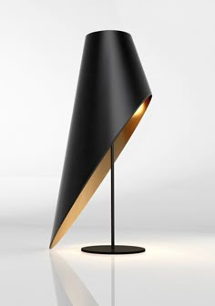 a black and gold lamp on a white surface