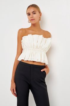 The Sheen Ruffled Strapless Top is a sophisticated versatile piece. Its strapless tube top style features accordion shirring at the neckline for subtle texture with elastic at the waist for a comfortable secure fit. A removable shoulder strap provides additional support and style options. Tube top Accordian shirring Elastic at waist Back zipper closure Removable shoulder strap Hand wash cold Do not bleach Do not tumble dry Iron low Shell: 78% Rayon 22% Nylon Lining: 92% Polyester 8% Spandex Excl Jumpsuit Fall, Knitwear Trends, Knit Loungewear, Strapless Bodycon Dress, Tweed Dress, Blazer And Shorts, Heat Styling Products, Geek Chic, Leather Dresses